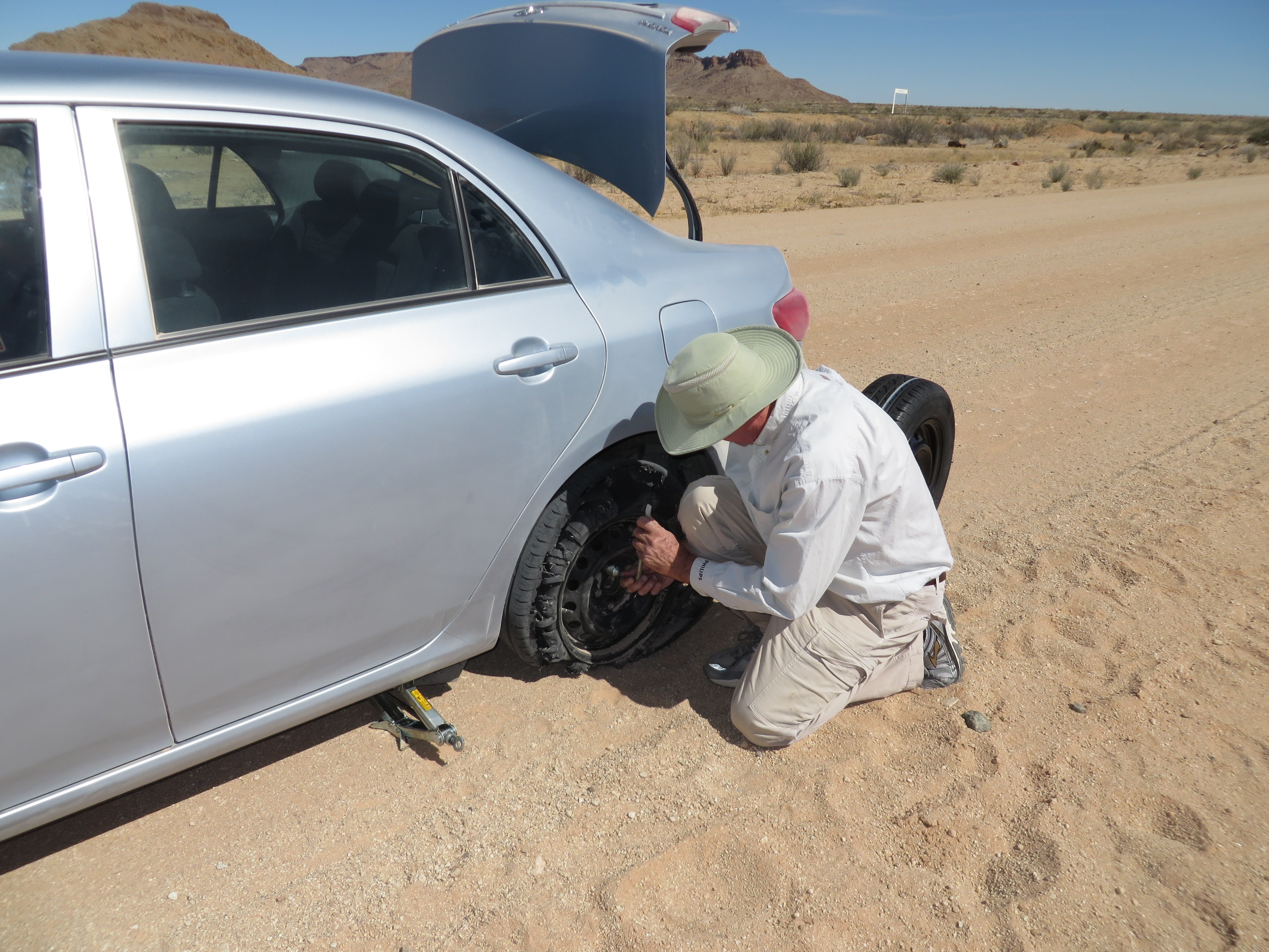 Derek changing a tire in the Kalahari desert